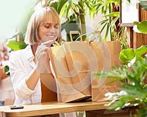 Woman, shopping bags and outdoor cafe with smile for discount, sale and retail therapy with bargain. Person, shopper and