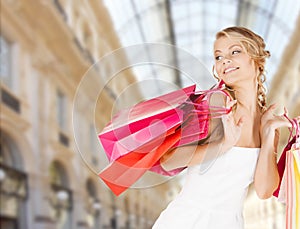 Woman with shopping bags over mall background