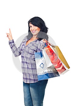 Woman with shopping bags pointing