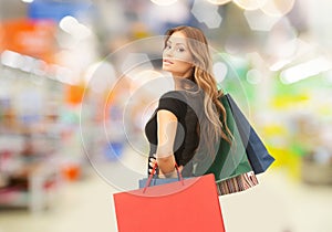 Woman with shopping bags at store or supermarket