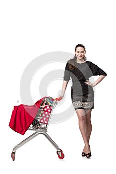 The woman with shopping cart and bags isolated on white