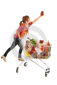 Woman with Shopping cart picking food from high cupboard