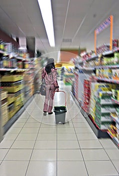 Woman with shopping cart in a Supermarket