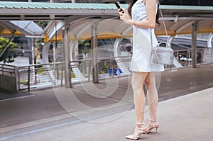 Woman shopping on mobilephone and walking on street