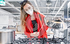 Woman shopping for new stove during reopening of economy