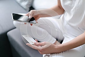 woman shopping online with cell phone and credit card
