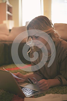 Woman shopping online with her credit card.