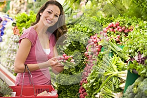 Woman shopping for produce in supermarket