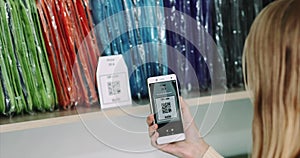 Woman shopping scanning qr code with smartphone