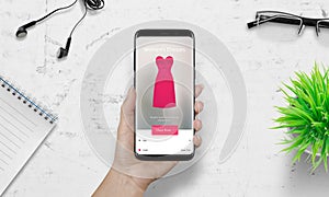 Woman shopping with smart phone. Pink woman dress on ecommerce app
