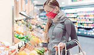 Woman shopping in supermarket during coronavirus lockdown