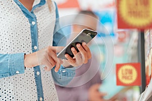 Woman shopping and using her phone