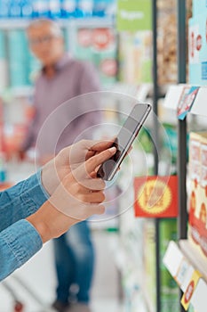 Woman shopping and using her phone