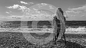 Woman on shore of Aegean Sea. Carian Trail, Turkey. Serenity, tranquility, solitude. Black and white.