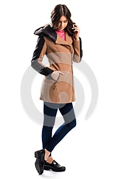 Woman in short beige coat.