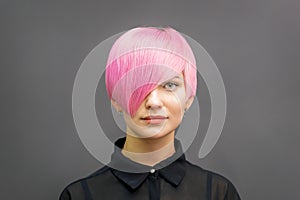 Woman with short bright pink hair