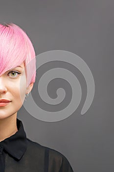 Woman with short bright pink hair