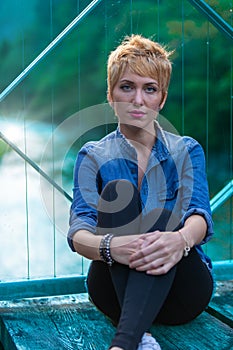 Woman, short hair, appreciating waterways, sunset, bridge, trave