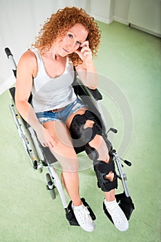 Woman in shorts and t-shirt seated in wheelchair
