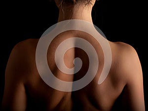 Woman shoulder blade back spine black background