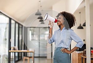 woman shouting loud holding a megaphone, expressing success