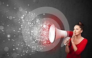 Woman shouting into megaphone and glowing energy particles explode