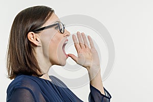 A Woman shouting, screaming portrait in profile, white background.