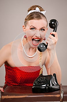 Woman shouting into telephone