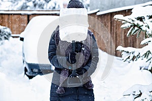 woman with shovel cleaning snow around car. Winter shoveling. Removing snow after blizzard