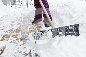 Woman shoveling and removing snow outside