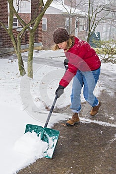 Woman Shoveling Winter Snow