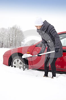 Woman shovelling and removing snow