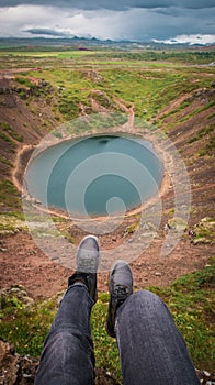 Woman show the blue lake near mountains. Icland