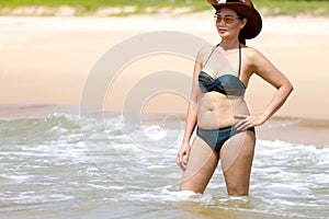 Woman show body sex symbol with bikini hat and wave