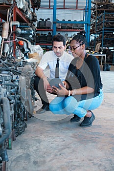 Woman show information on tablet to man. Diversity of two people, black African worker woman work with caucasian business manager