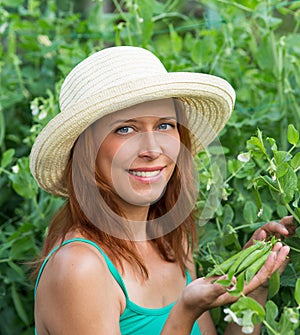 Woman show pods fresh peas