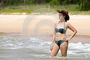 Woman show shape sex symbol with bikini hat