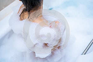 Woman shower and relaxing in bathtub