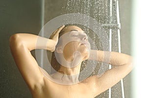 Woman showering under water jet