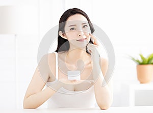 Woman showing beauty product on hand