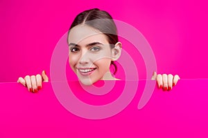 Woman showing blank signboard. Girl holding a blank paper isolated background. Sheet of paper in hands. Copy space