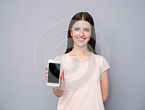 Woman showing blank smartphone screen