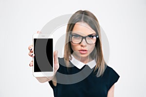 Woman showing blank smartphone screen