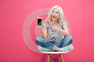 Woman showing blank smartphone screen