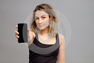 Woman showing blank smartphone screen