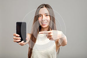 Woman showing blank smartphone screen