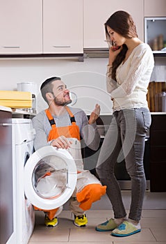 Woman showing broken washing machine