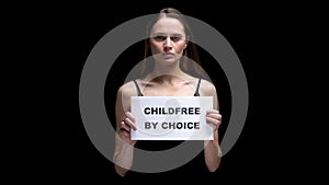 Woman showing childfree by choice sign, voluntary refusal from children, freedom
