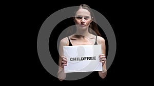 Woman showing childfree sign, conscious refusal from children and maternity photo