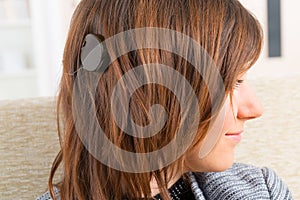 Woman showing cochlear implant photo